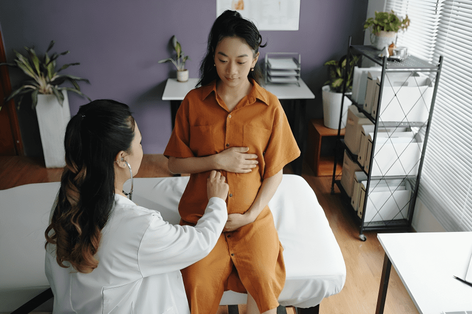 Pregnant woman examined by doctor in clinic.