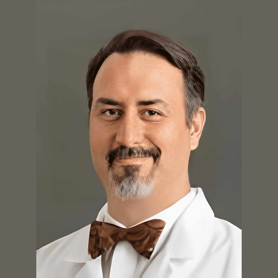 Man with brown bow tie and beard.